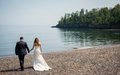 A bride and groom on the beach at Superior Shores Resort in Two Harbors, MN