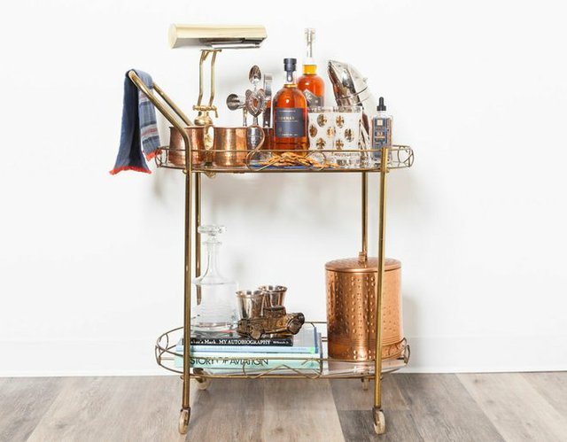 fancy cart with liquor, cups, books and ice bucket